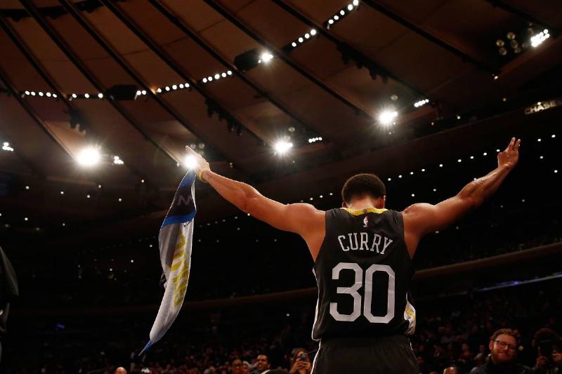 NEW YORK, NY - OCTOBER 26: Stephen Curry #30 of the Golden State Warriors celebrates on the bench against the New York Knicks during the fourth quarter at Madison Square Garden on October 26, 2018 in New York City. NOTE TO USER: User expressly acknowledges and agrees that, by downloading and or using this photograph, User is consenting to the terms and conditions of the Getty Images License Agreement.